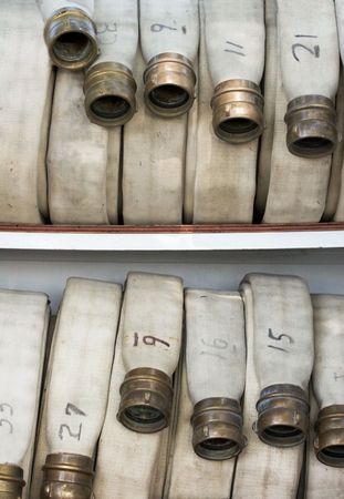 Fire Hoses rolled up on the back of a firetruck.の写真素材