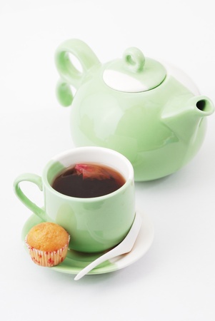 Tea being poured into tea cup isolated on a white backgroundの写真素材