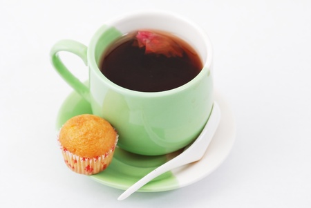 Tea being poured into tea cup isolated on a white backgroundの写真素材