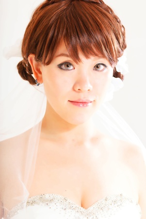 bride sitting in wedding dress, studio shotの写真素材