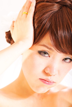bride sitting in wedding dress, studio shotの写真素材