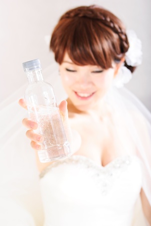 bride sitting in wedding dress, studio shotの写真素材