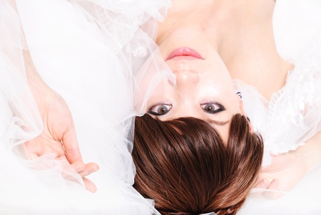 bride sitting in wedding dress, studio shotの写真素材