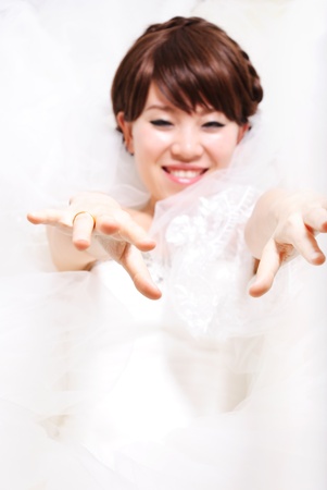 bride sitting in wedding dress, studio shotの写真素材