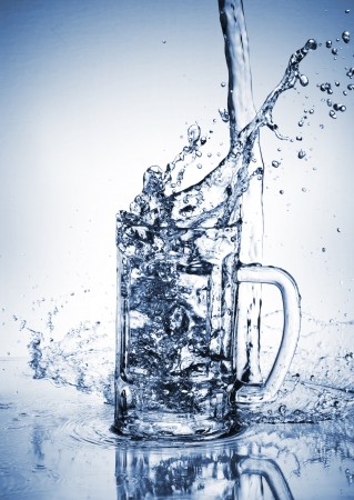 Water splash out of glassの写真素材