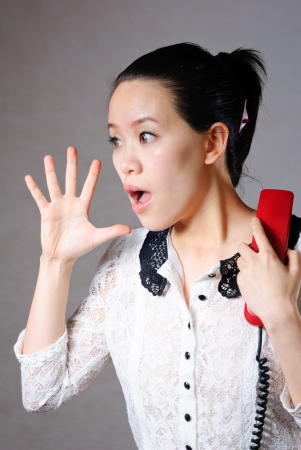 Young angry woman yelling on phoneの写真素材