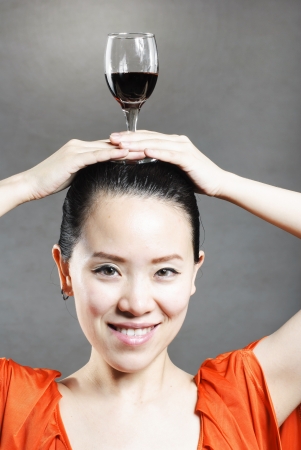 Beautiful woman with glass red wineの写真素材