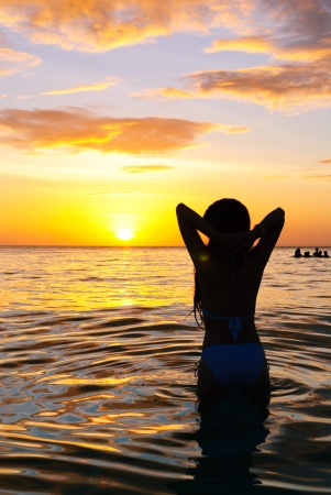 sunset yoga woman on sea coastの写真素材