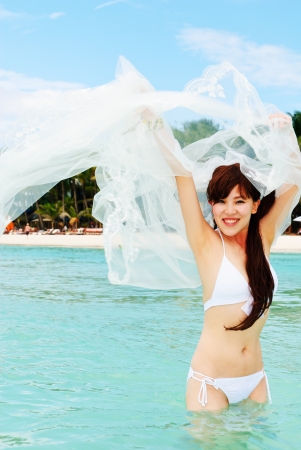 Beautiful bikini model posing on the beachの写真素材