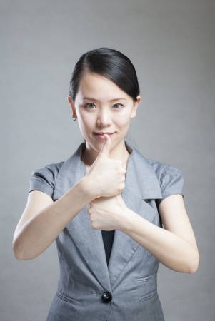 portrait of a young beautiful woman with two thumbs upの写真素材