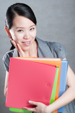 bright picture of beautiful woman with foldersの写真素材