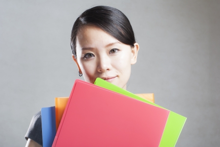 bright picture of beautiful woman with foldersの写真素材