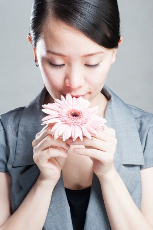 Beautiful girl holding orchid flower in her handsの写真素材