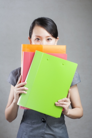 bright picture of beautiful woman with foldersの写真素材