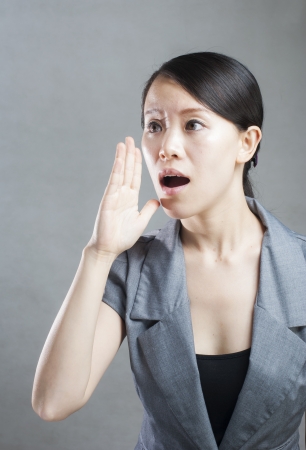 Young woman yelling isolated on white background.の写真素材