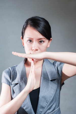 Serious business woman making stop sign over white, focus on handの写真素材