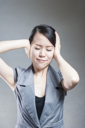 Young woman with head pain on white backgroundの写真素材
