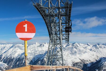 Piste sign in the mountains Alps near the sky lift supportsの写真素材