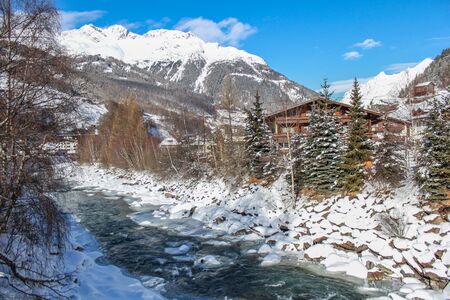 Mountain river running down the hill through the villageの写真素材
