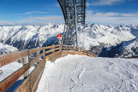 Ski slopes near wooden fence in Alps in Austriaの写真素材