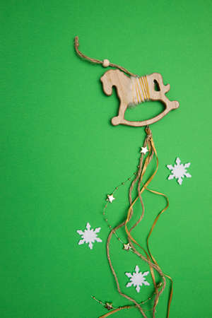 Christmas decoration wooden horse with stars, ribbons and beadsの写真素材