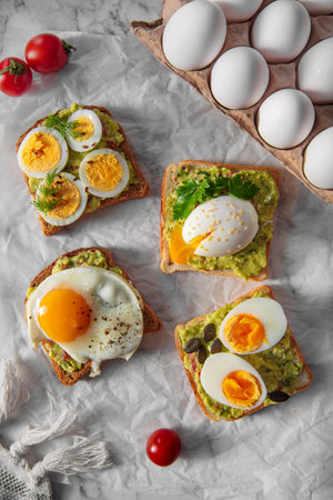 toast with guacamole and different kinds of eggs (poached eggs, fried eggs, boiled eggs, sliced...