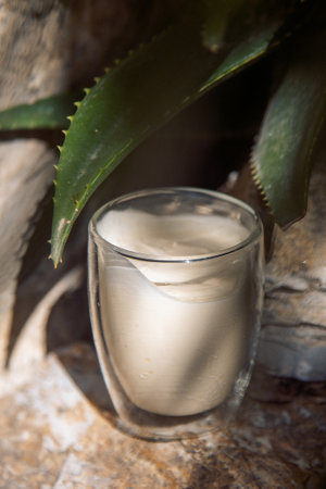 A scoop of ice cream served in a transparent glass cup
