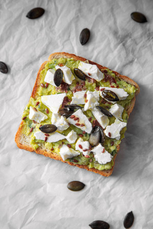 Creamy guacamole topped with tangy feta cheese and crunchy pumpkin seeds for a delightful flavor...