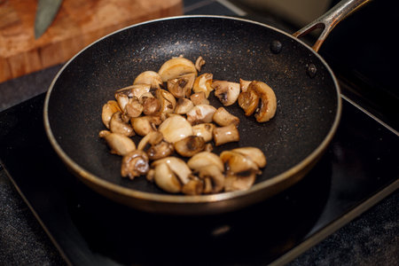 pan frying champignon mushroomsの写真素材