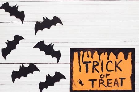 paper origami bats on a gray background, decorations for the holiday Halloween