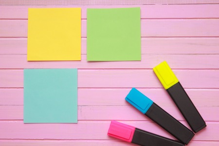 Top view of blank notebook page on pastel colored background office desk with different objects. Minimal flat lay style.の写真素材