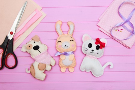 Cute felt toys made of felt. Handicraft materials on wooden background with copy space for text. Simple handmade toy for Valentine's day, mother's dayの写真素材