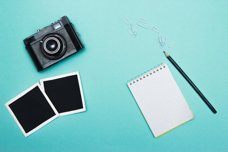 vintage retro camera on wooden table background with blanks photo to placed your pictures, bouquet...