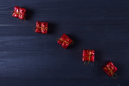 Colourful, vintage Christmas presents on the black wooden table .Background with copy space.の写真素材