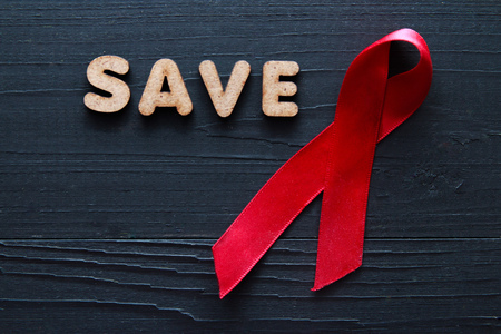 World AIDS day concept. red ribbon on black background.