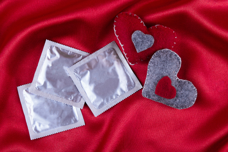 red heart and condom, safe sex, valentine's conceptの写真素材