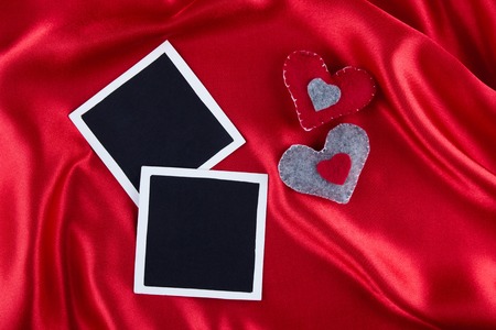 Photos frames on rustic red satin backgroundの写真素材