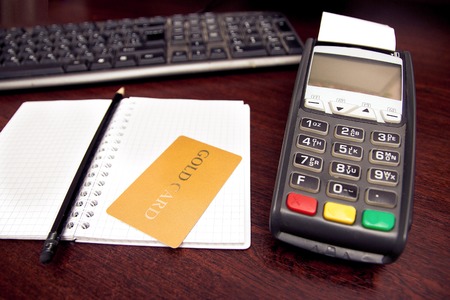 Payment terminal for paying credit card on laptop keyboard, credit card reader, finance and banking conceptの写真素材