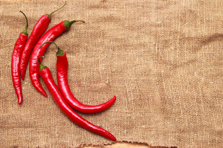 Red hot chili peppers in bag on wooden backgroundの写真素材