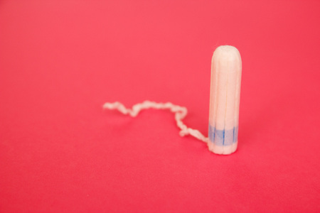 Cotton tampons on pink background. Menstrual period concept. Woman hygiene protection.の写真素材