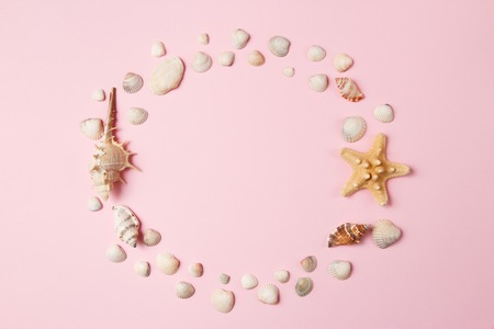 Seashells and starfish on a pale pink background. Summer time concept. Top view.の写真素材