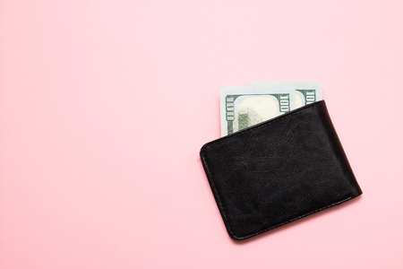 Black leather wallet with money on pink background. Top viewの写真素材