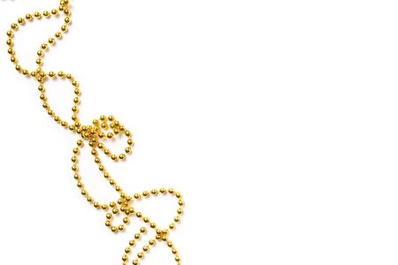 Golden beads isolated on white. Christmas frame.