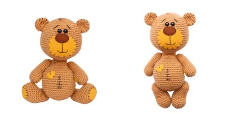 A small knitted teddy bear amigurumi. Handmade. Isolated on whiteの写真素材