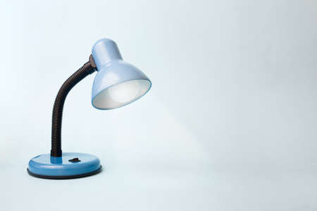 Creative concept of the idea. Learning and finding inspiration. Blue lamp on a blue pastel backgroundの写真素材