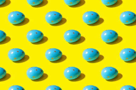 Easter seamless pattern. Blue painted egg on a yellow background. Creative packaging design in the concept of minimalismの写真素材