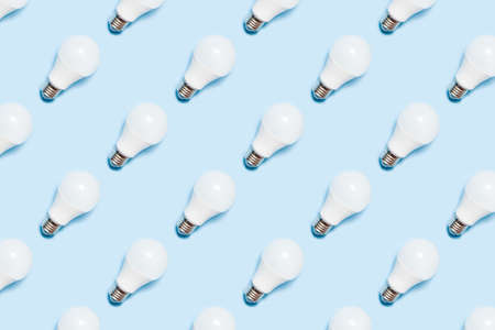 Creative seamless pattern of LED light bulbs on blue background. Energy saving concept. Minimalism,...