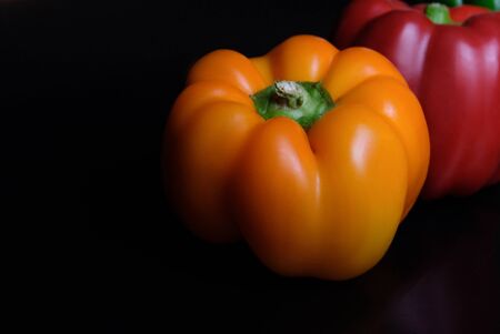 red yellow pepper on a black background