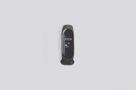 Black fitness tracker isolated on gray background