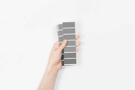 Color swatches with color of the year 2021 in the hand - Ultimate Gray.の写真素材